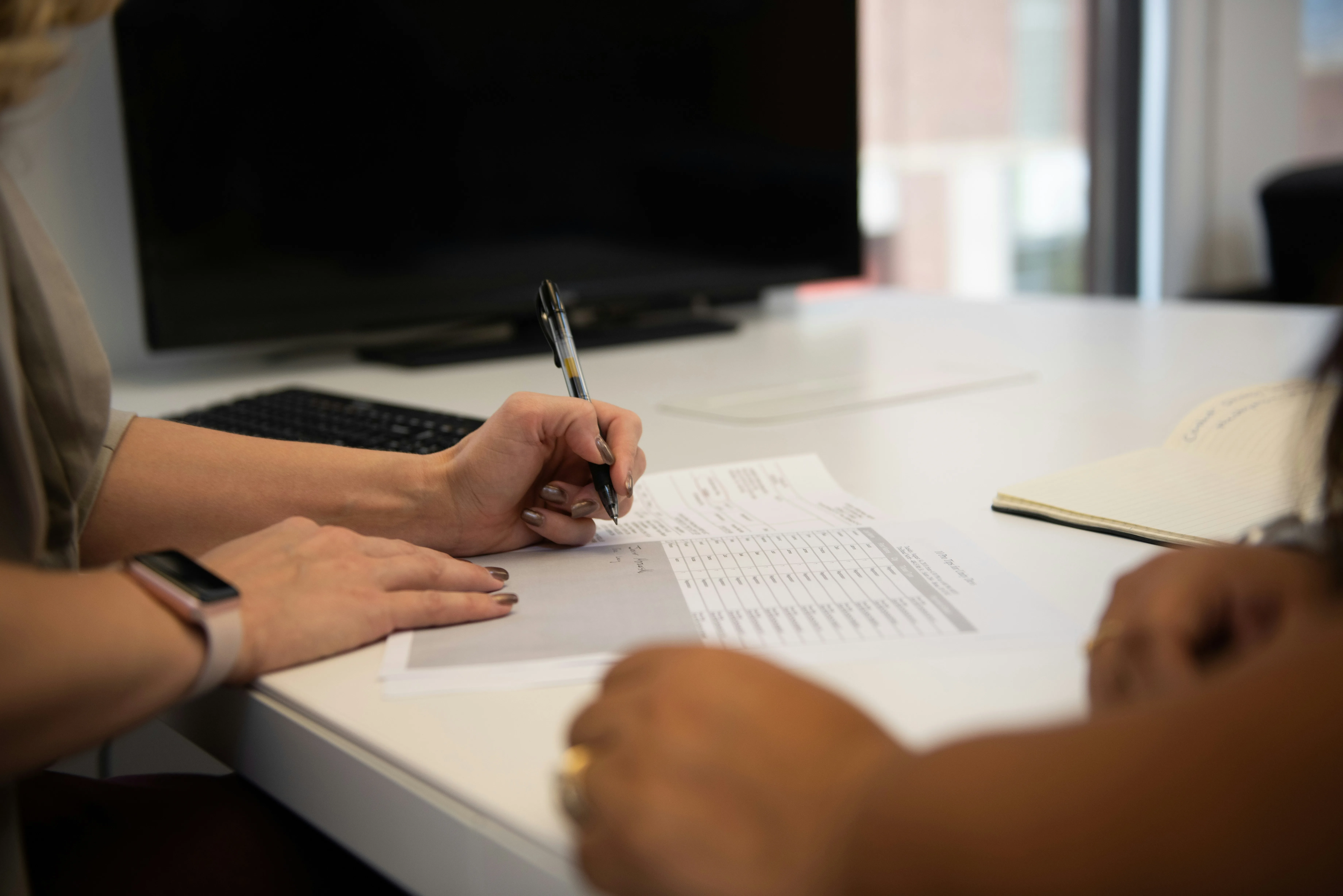 Project Orbit: colleagues reviewing documents and sign-off on a desk